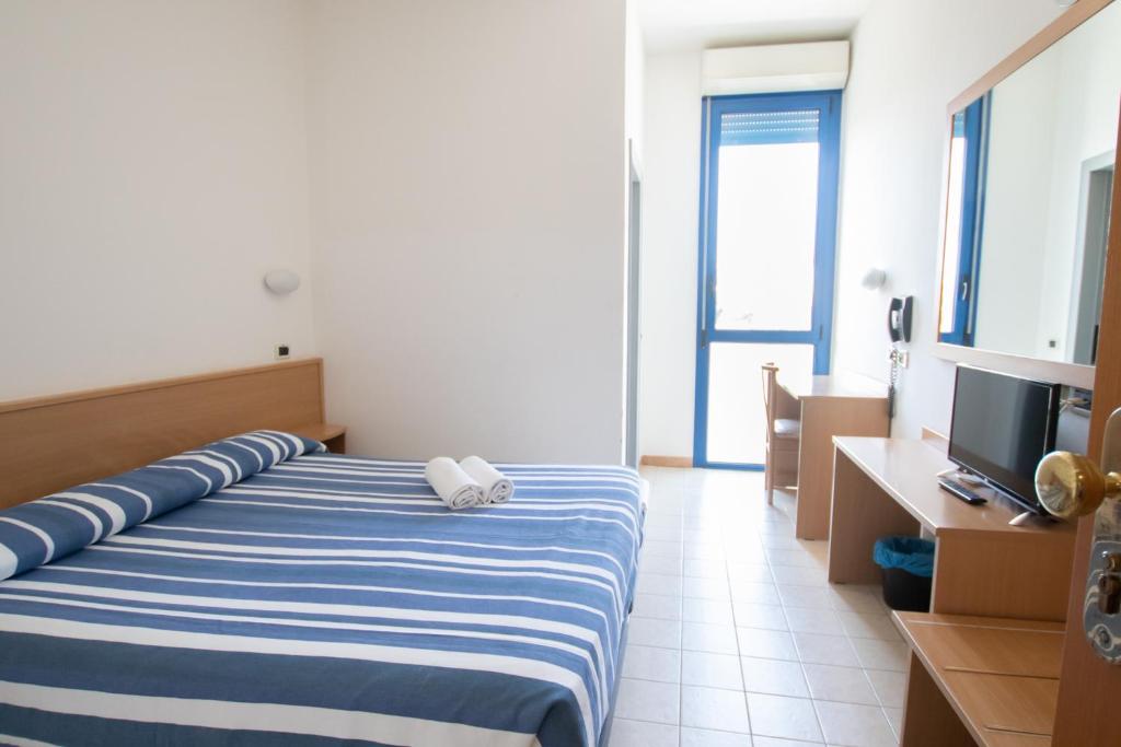 Postel nebo postele na pokoji v ubytování Piccolo Hotel