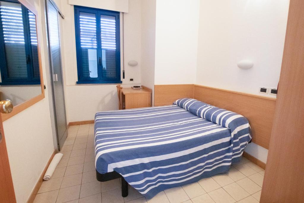 Postel nebo postele na pokoji v ubytování Piccolo Hotel