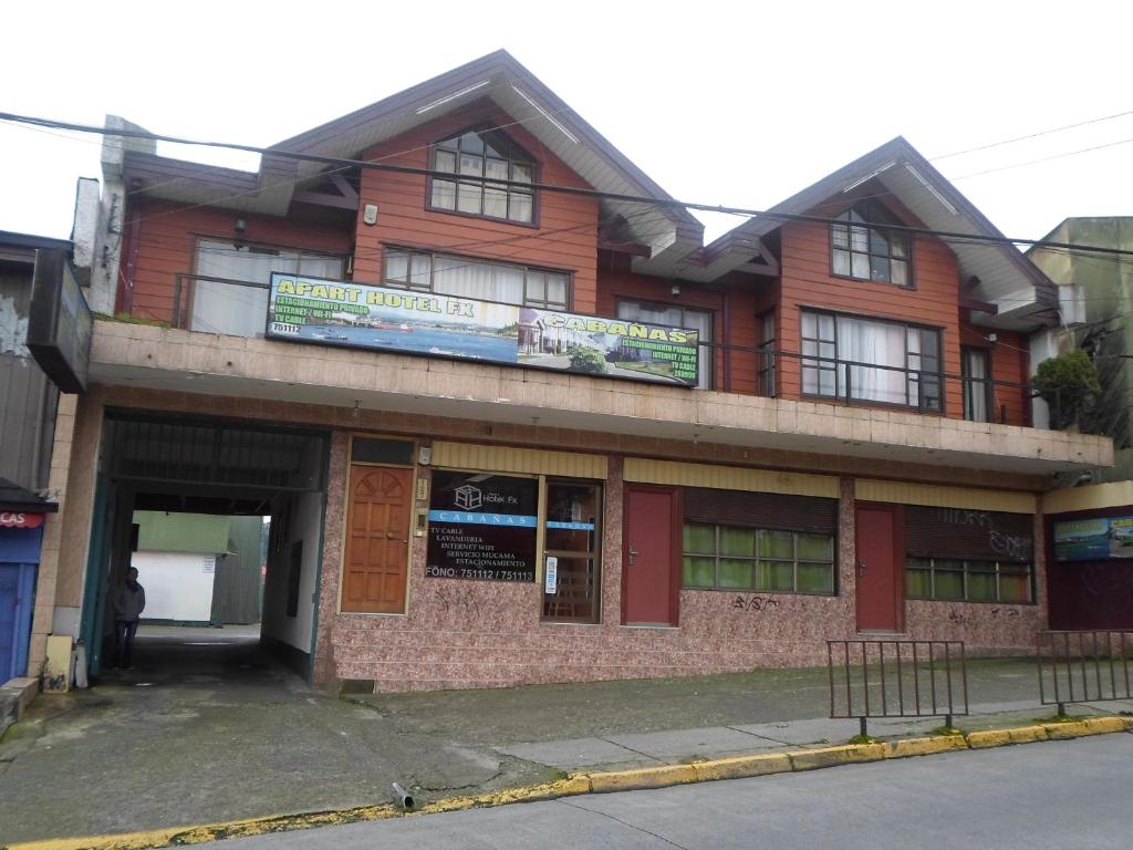 a building on the corner of a street at Hostal Fx in Puerto Montt
