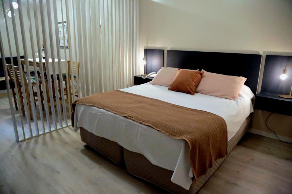 a bedroom with a large bed with two pillows on it at RecoBerta Studio. Vivir Recoleta!! in Buenos Aires