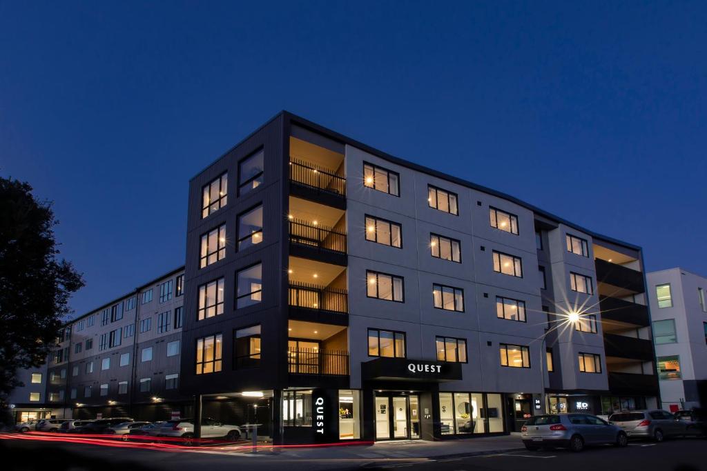 un edificio alto y negro con muchas ventanas por la noche en Quest Mount Eden en Auckland