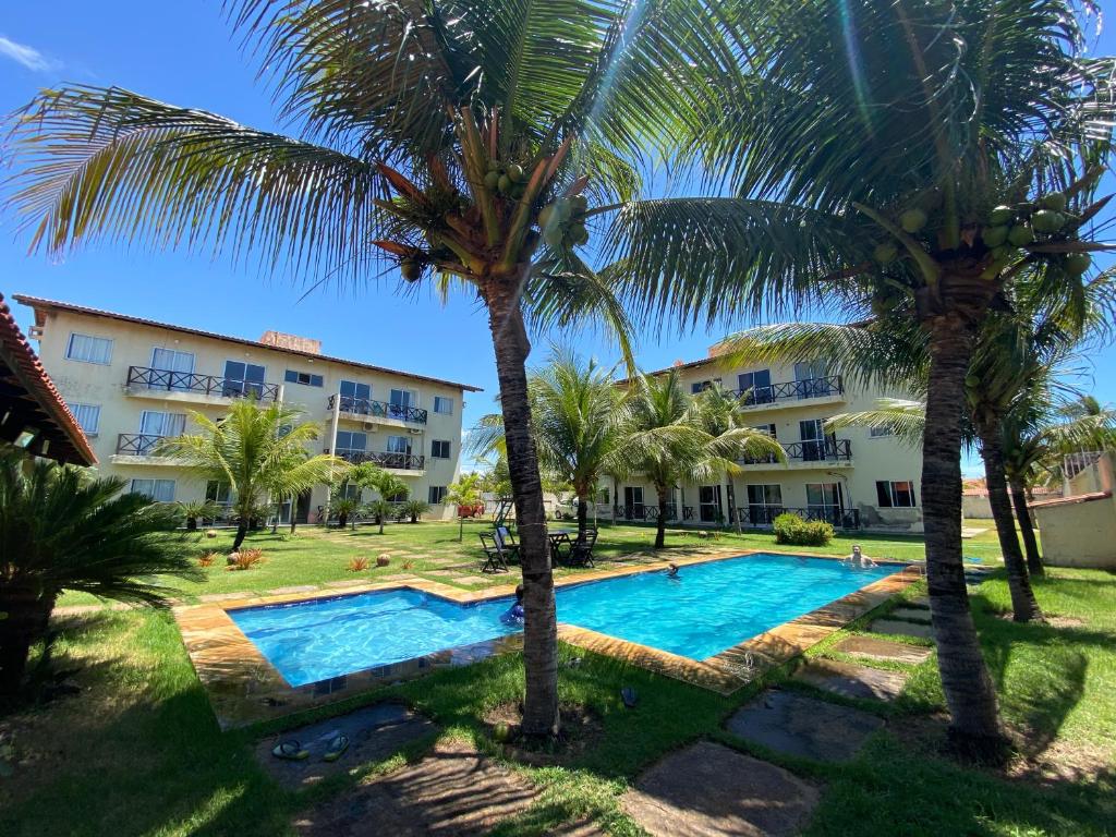 een uitzicht op het resort met palmbomen en een zwembad bij Apto Praia da Taíba Vista Mar in Taíba