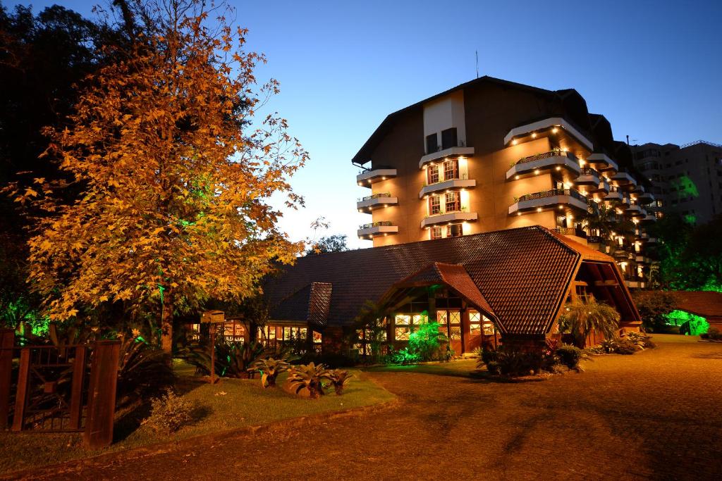 a large building in front of a building at Hotel Águas Claras in Santa Cruz do Sul