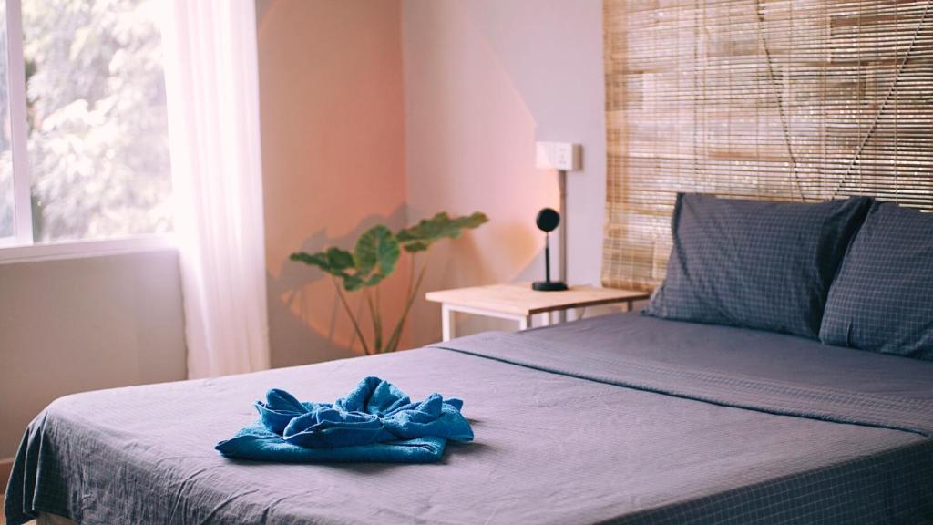 a blue towel sitting on top of a bed at Monkey Republic Kampot in Kampot