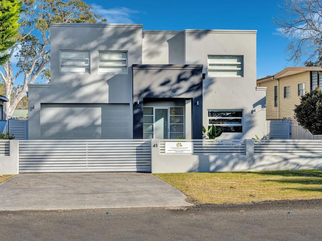 a large white house with a driveway at Gather at Vincentia in Vincentia