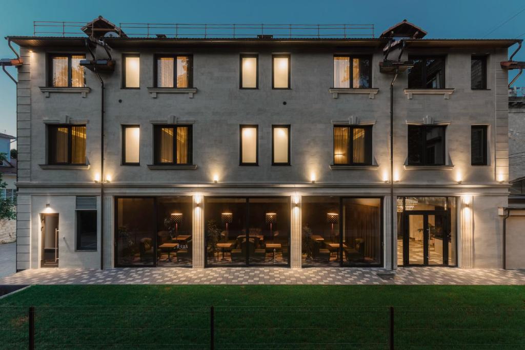 a large building with many windows and lights at Plai Hotel in Chişinău