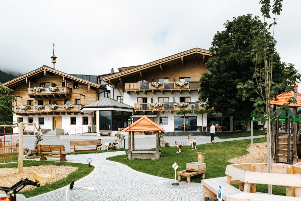 a large building with a playground in front of it at Hotel Thurnerhof in Saalbach Hinterglemm