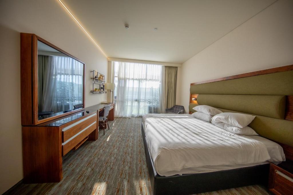 Postel nebo postele na pokoji v ubytování Garden Hotel Boutique & Events