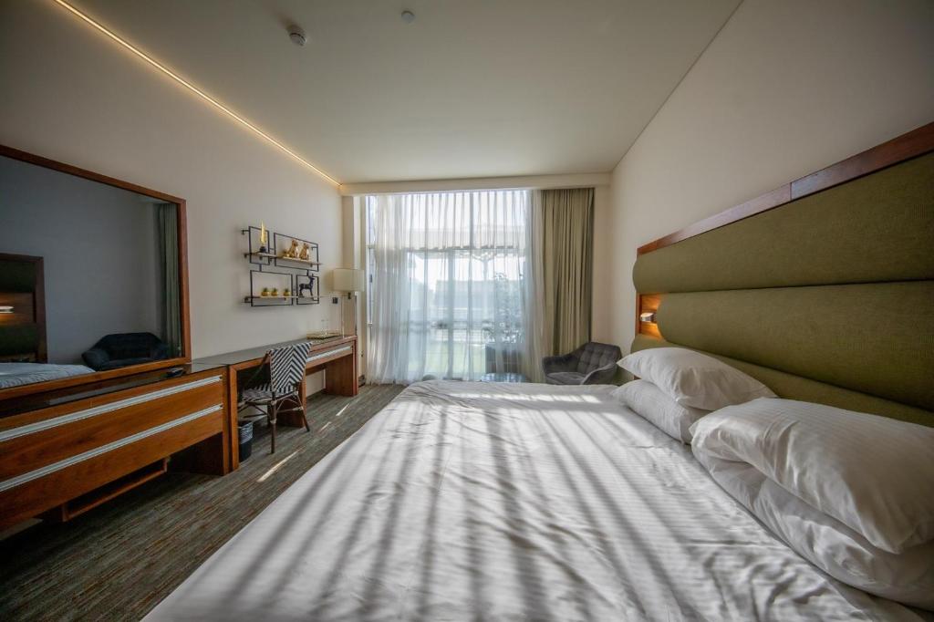 Postel nebo postele na pokoji v ubytování Garden Hotel Boutique & Events