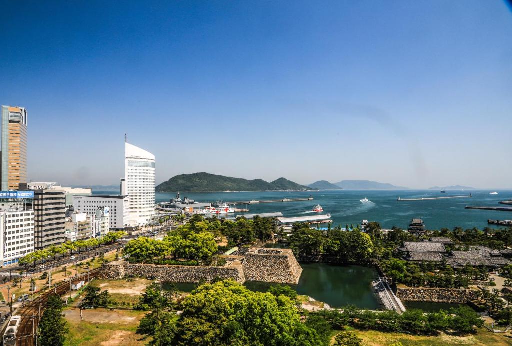 a view of a city with the ocean and buildings at JR Hotel Clement Takamatsu in Takamatsu