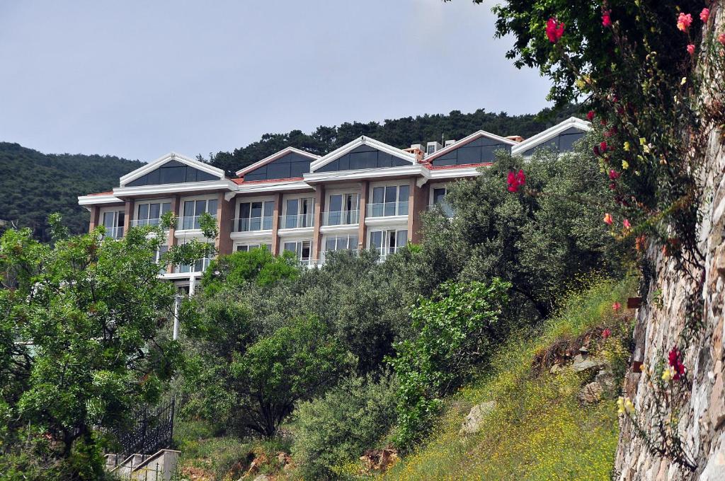 a large building on the side of a hill at Rezone Health & Oxygen Hotel Kazdağları in Altınoluk