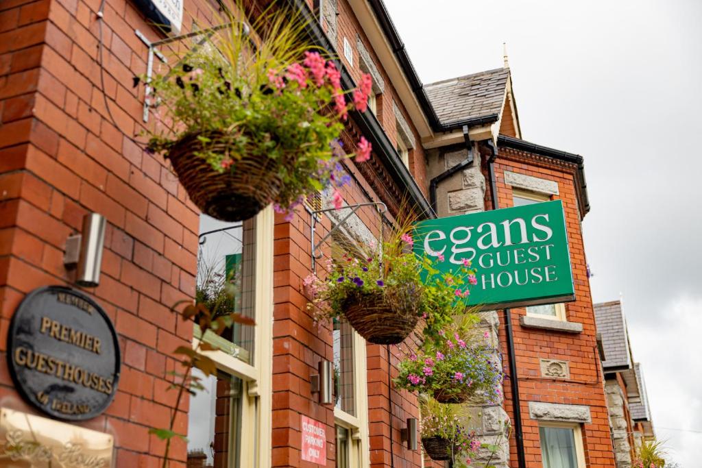 a building with potted plants on the side of it at Egans House in Dublin