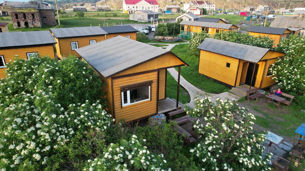 a model of a tiny house in a field of flowers at Teriberka Tour in Teriberka