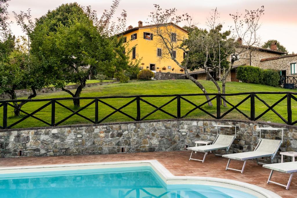 a villa with a swimming pool and a house at Poggio Agli Ulivi in Barberino di Mugello