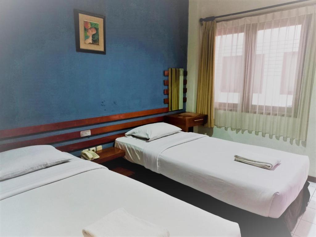 Postel nebo postele na pokoji v ubytování N Hotel Harmoni Jakarta