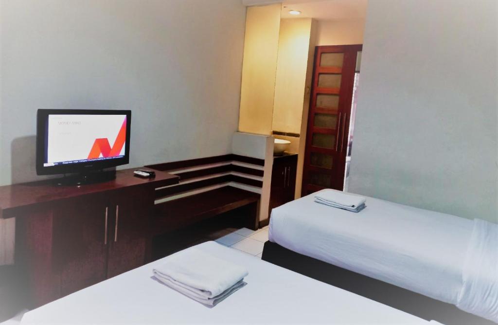 Postel nebo postele na pokoji v ubytování N Hotel Harmoni Jakarta
