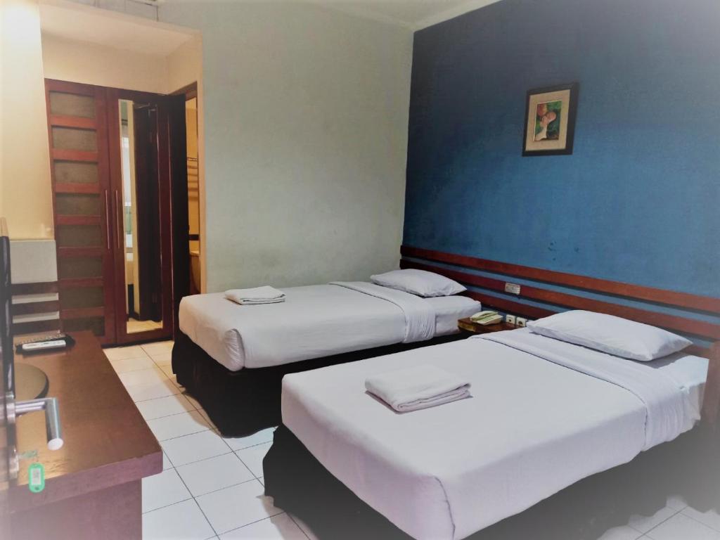 Postel nebo postele na pokoji v ubytování N Hotel Harmoni Jakarta