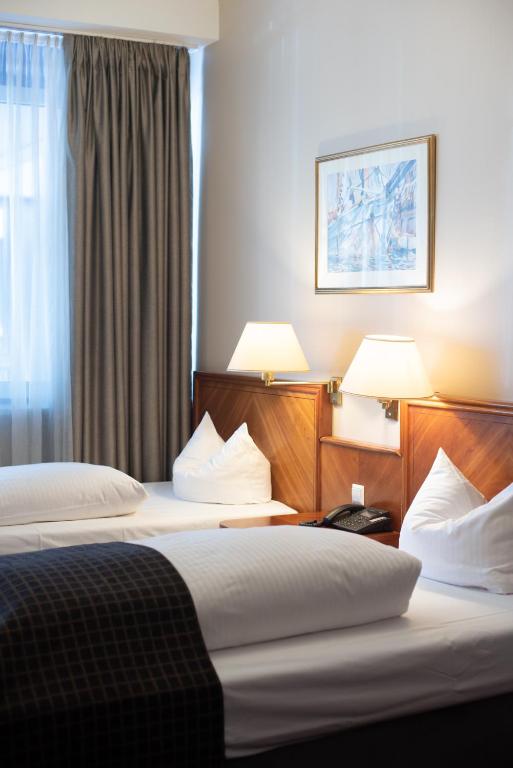 Postel nebo postele na pokoji v ubytování ROSS Hotel