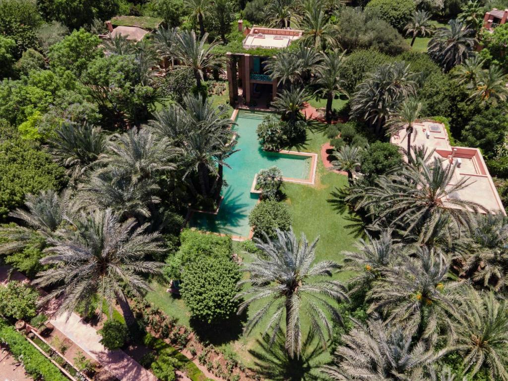 an overhead view of a swimming pool with palm trees at Villa DAR EL HANA in Marrakesh