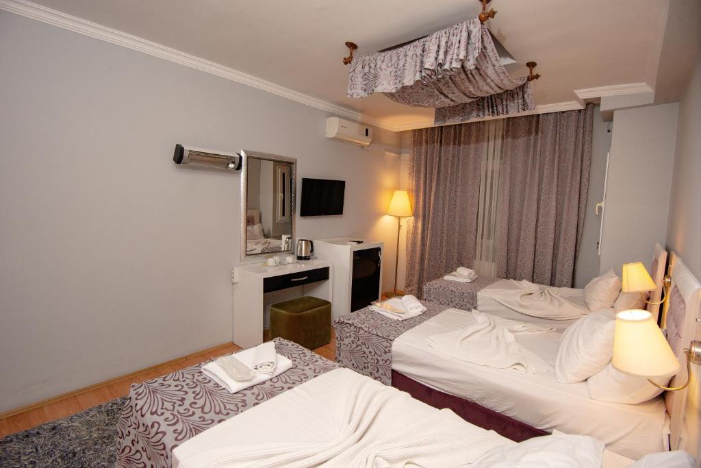 Postel nebo postele na pokoji v ubytování SRF Hotel