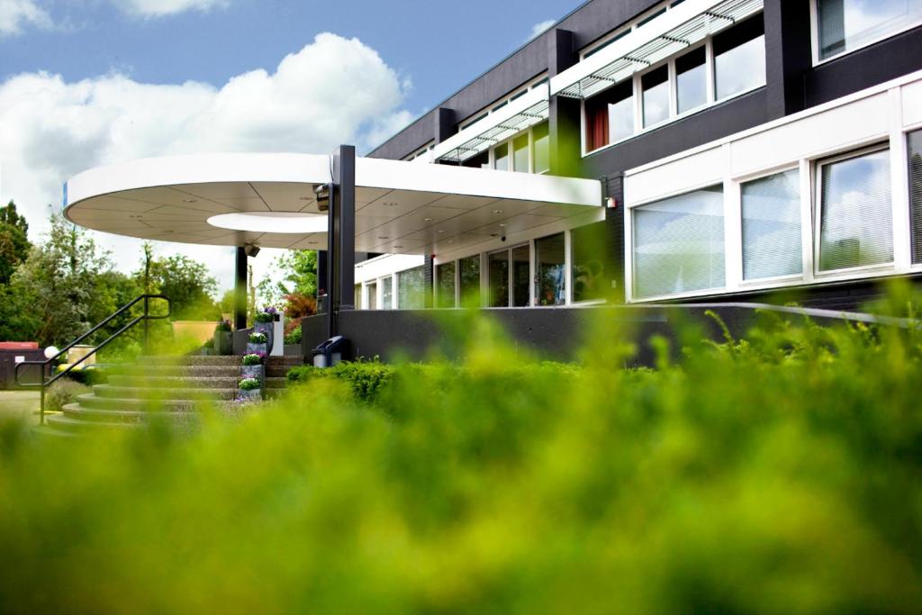 a building with stairs in front of a building at Amrâth Airport Hotel Rotterdam, BW Signature Collection in Rotterdam