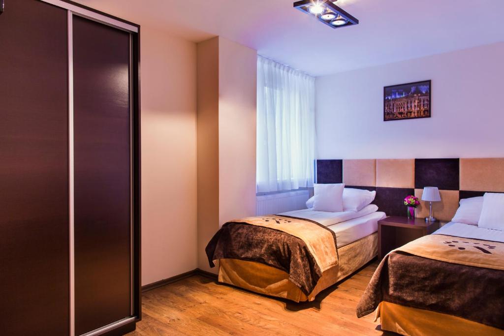 Postel nebo postele na pokoji v ubytování Boutique Hotel's III Piłsudskiego