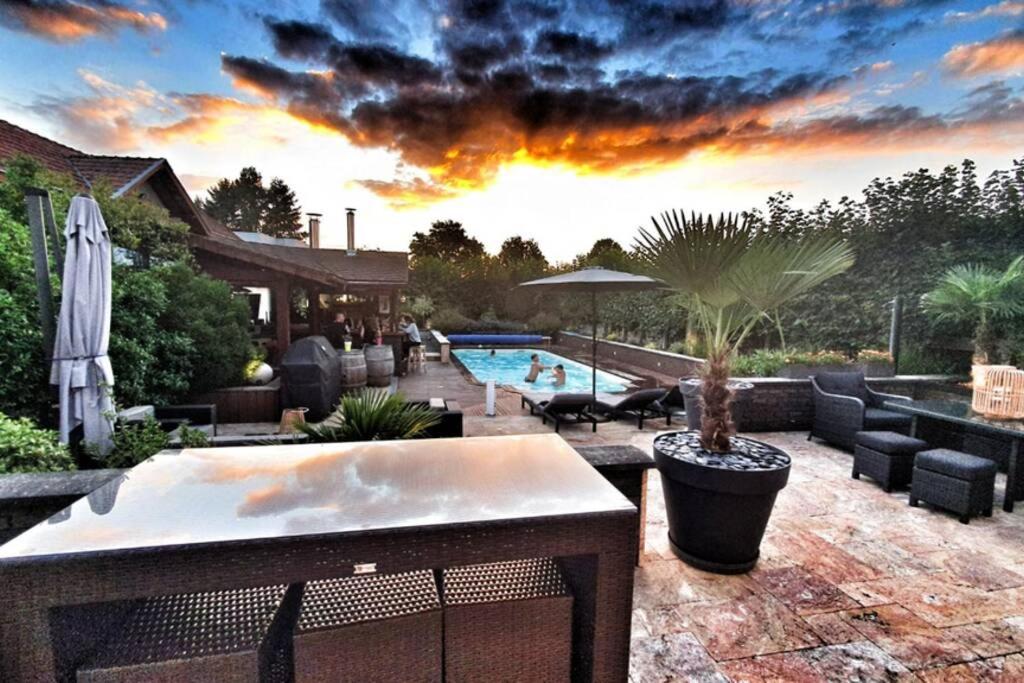 a backyard with a swimming pool and a sunset at La Tranquillité au Centre. in Toulon-sur-Arroux