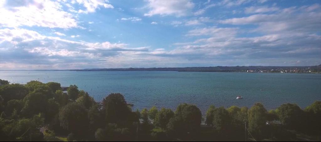 a large body of water with a boat in it at Apartments am Bodensee in Bregenz
