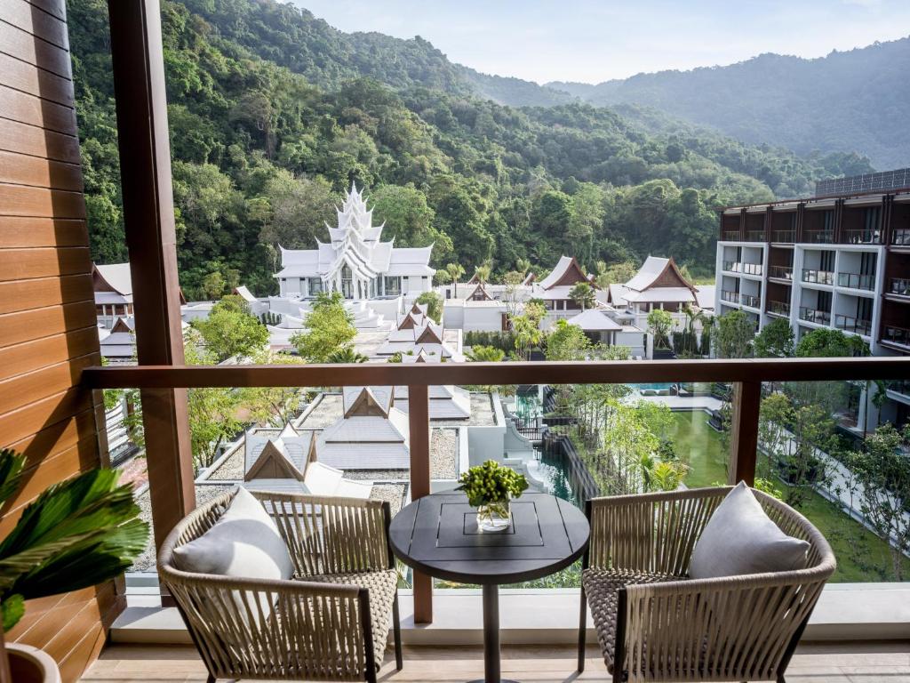 a balcony with a table and chairs and a view at InterContinental Phuket Resort by IHG in Kamala Beach