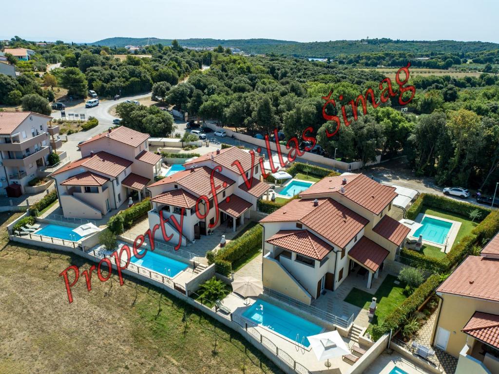 an aerial view of a house with a swimming pool at Villas Simag in Banjole
