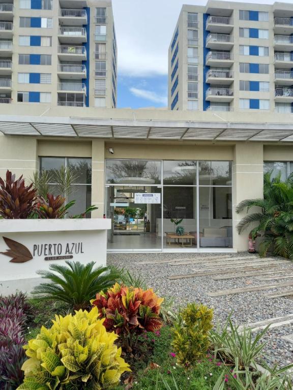 a building with a sign that reads puerto ayust at Excelente Apartamento Ricaurte, Puerto Azul Torre 10 Apto 208 in Ricaurte