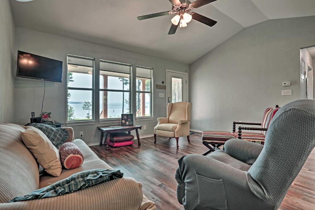 a living room with a couch and a ceiling fan at Relaxing Texas Getaway, 1 Mile to Boat Ramp! in Jefferson