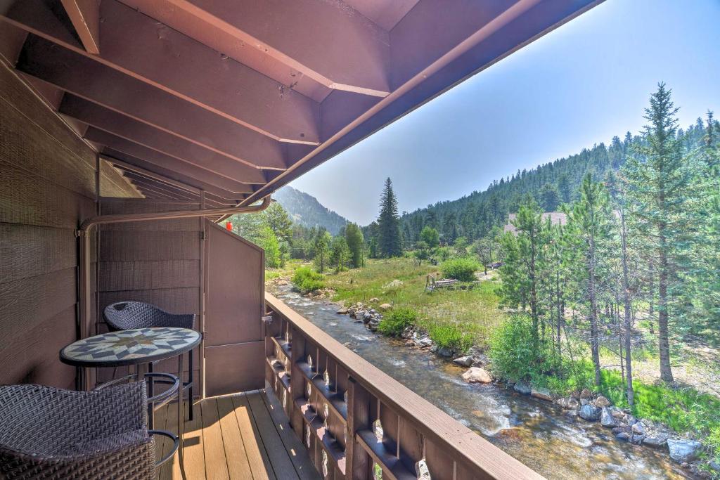 a balcony with a view of a river and trees at Lovely Estes Park Escape 1 Mi to National Park! in Estes Park