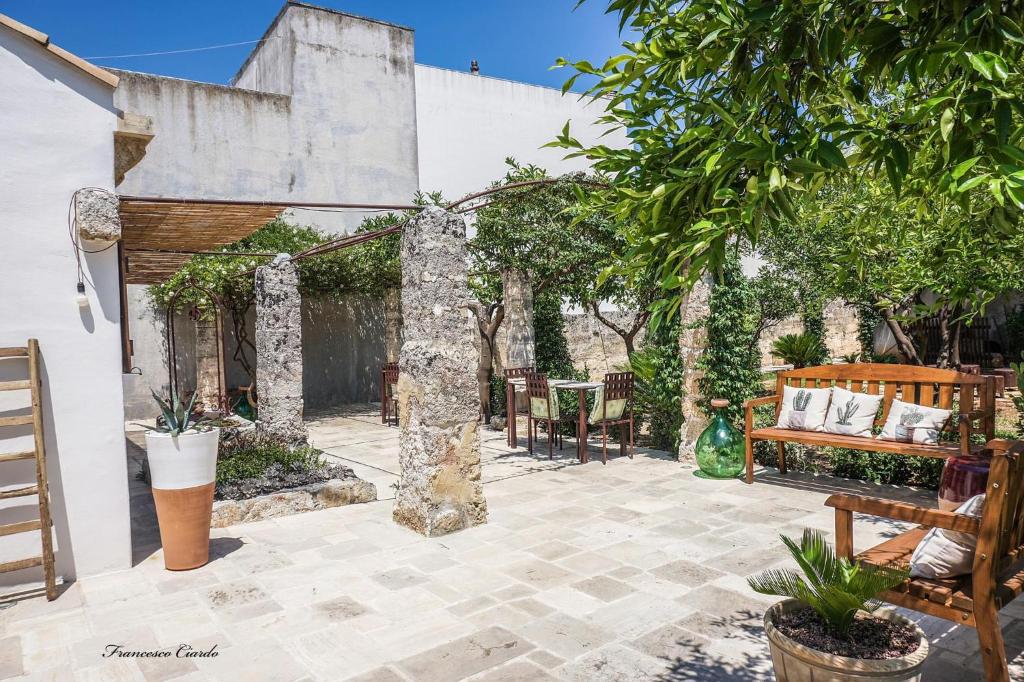 un patio extérieur avec des chaises et une pergola dans l'établissement Corte Piri, à Tricase