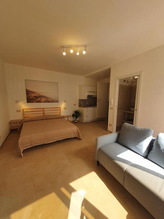 a living room with a bed and a couch at Loft Ionios in Noto Marina