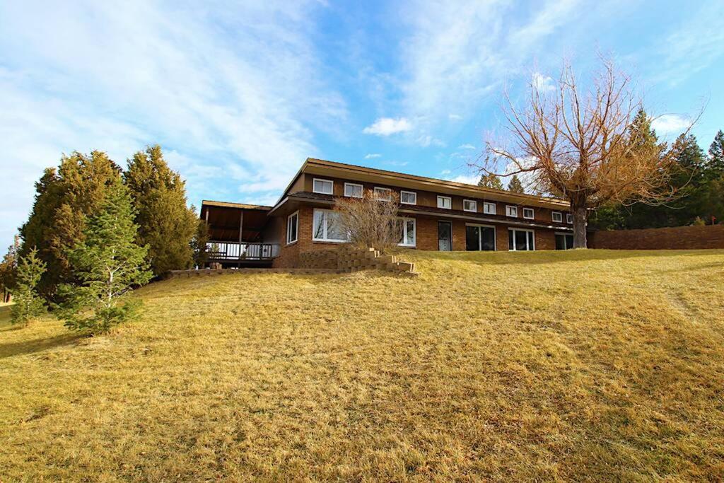 a large house sitting on top of a field at Charming, Spacious, Contemporary Mountain Retreat in Whitehall