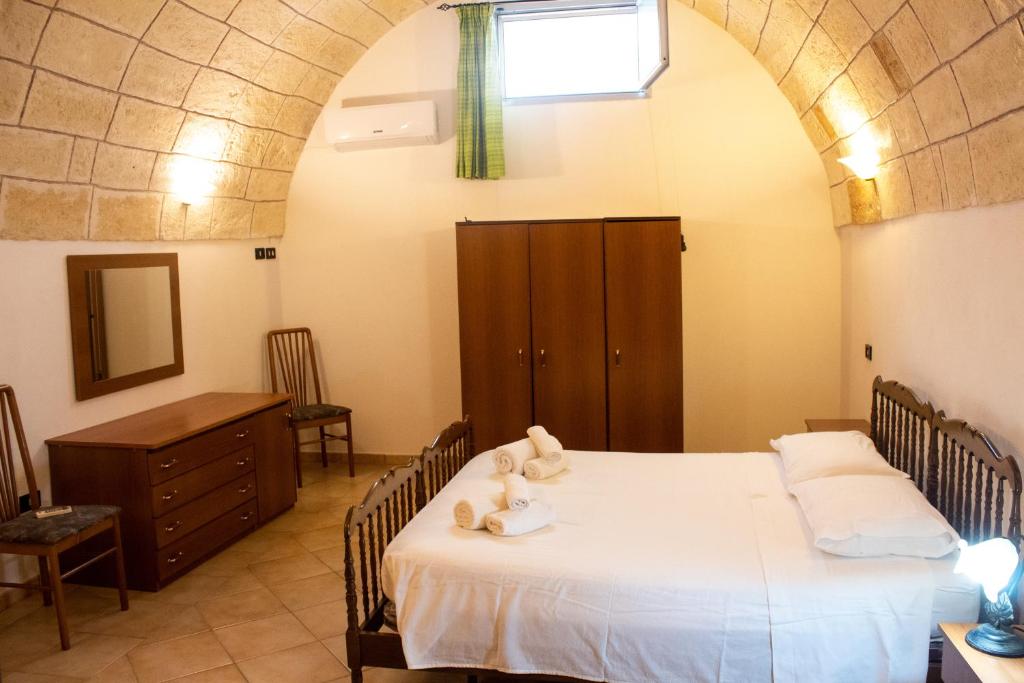 a bedroom with a bed with two teddy bears on it at Casavacanze Antonio in Leuca