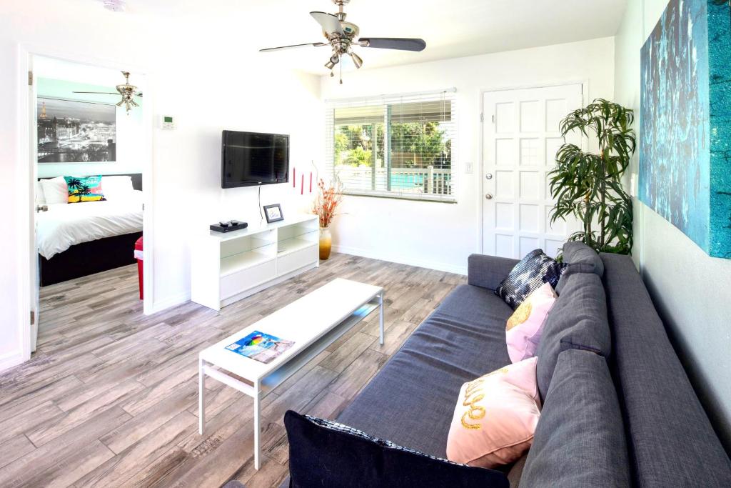 a living room with a couch and a table at Park Shore Suites St Pete Beach in St. Pete Beach