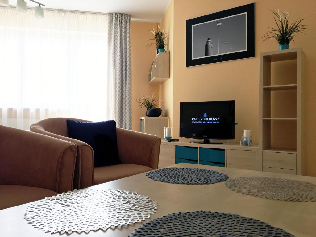 Televízia a/alebo spoločenská miestnosť v ubytovaní Apartament z balkonem ul. Spacerowa 2
