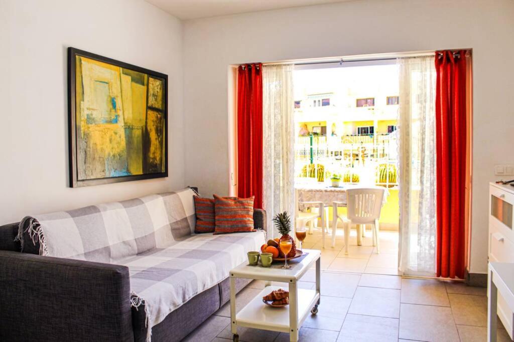 a living room with a couch and a table at Apartamento MareVerde Las Americas in Adeje