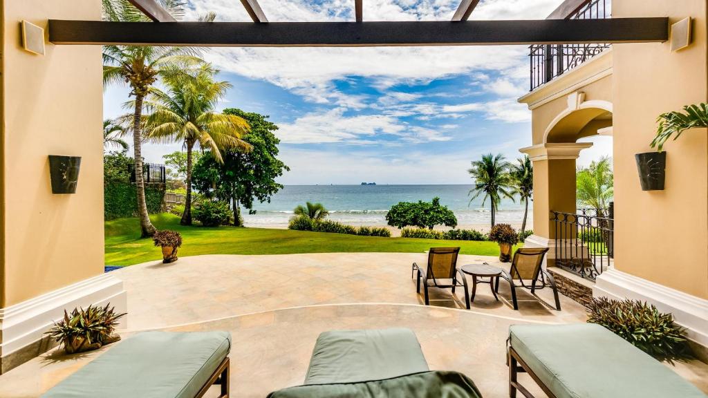 a patio with a view of the ocean at Stunning beachfront Flamingo mansion with incomparable ocean setting in Playa Flamingo