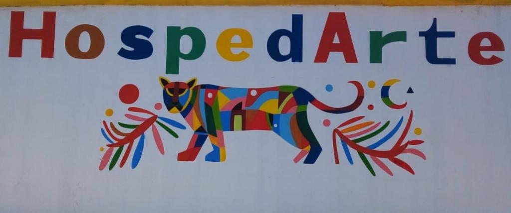a sign for a hospital with a dog painted on it at HospedArte Loreto in Loreto