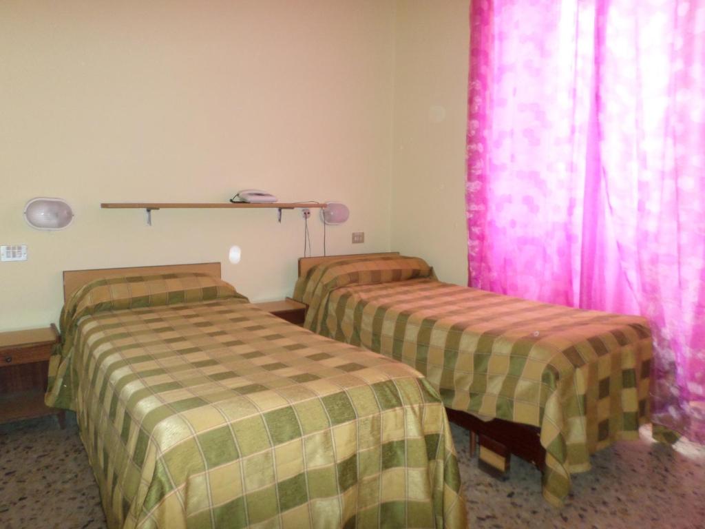 Postel nebo postele na pokoji v ubytování Hotel Aurora