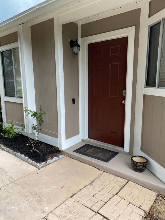 a front door of a house with a red door at Spacious Home, Close to Attractions, Sleeps 4 in Orlando