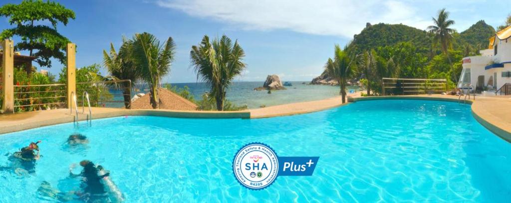 a swimming pool at a resort with a beach at Montalay Beach Resort in Koh Tao