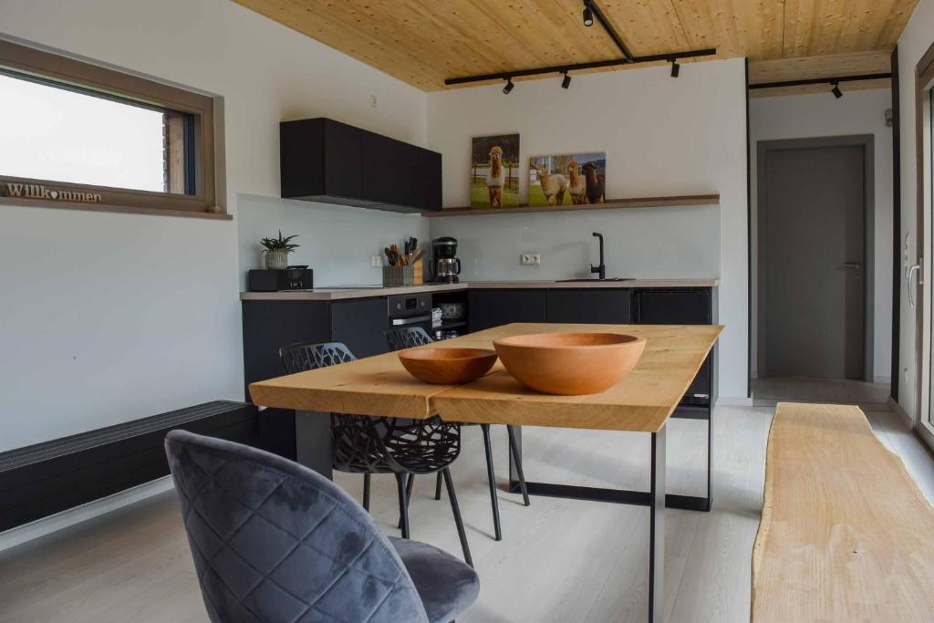a kitchen with a wooden table with two bowls on it at Chalet Seebauer in Neunburg vorm Wald