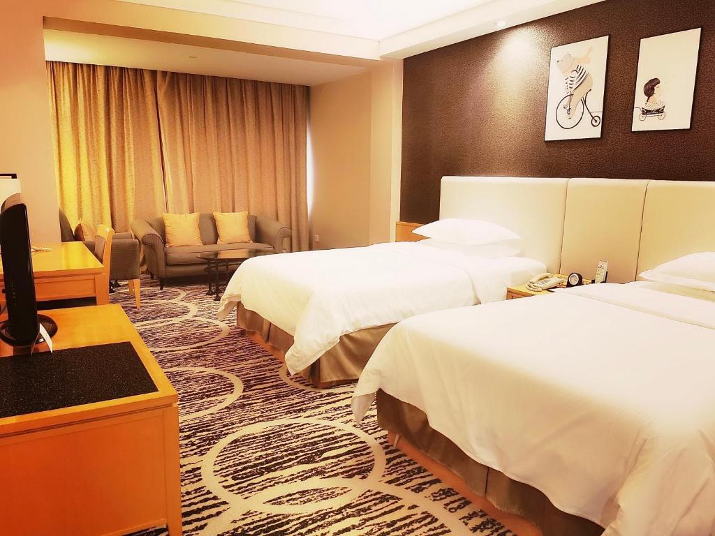 Postel nebo postele na pokoji v ubytování Guangzhou Baiyun Hotel