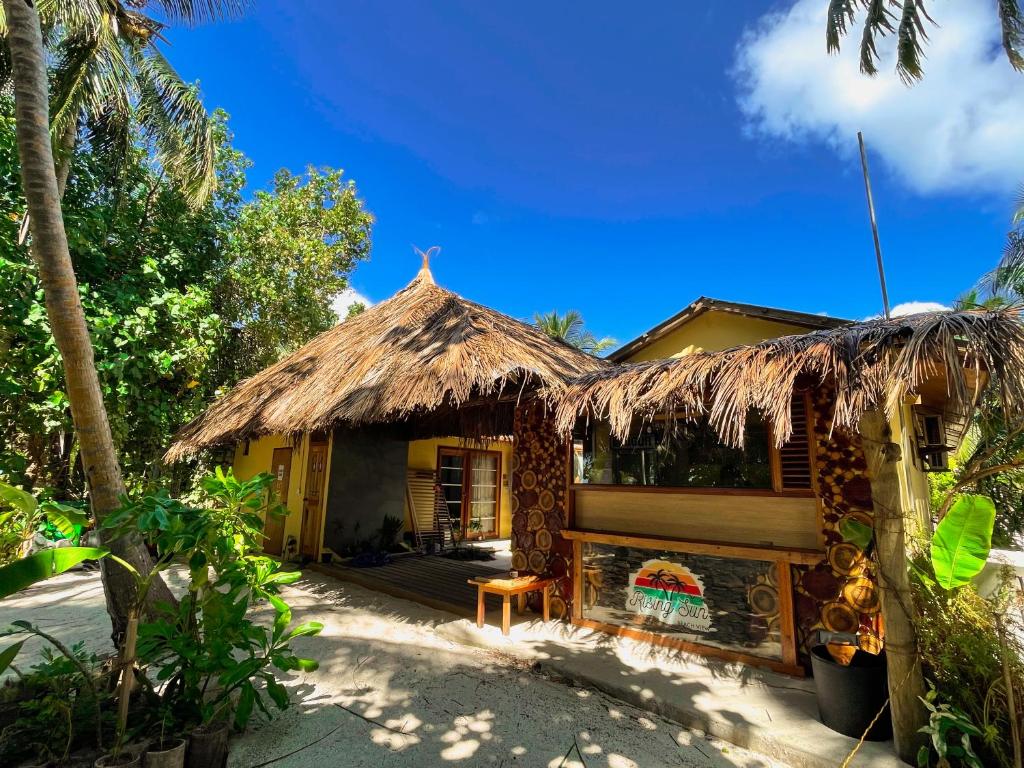 a small house with a thatched roof at RISING SUN BEACH VIEW in Thinadhoo