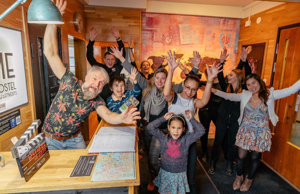 a group of people with their hands in the air at Time Hostel Jyväskylä, Boutique in Jyväskylä