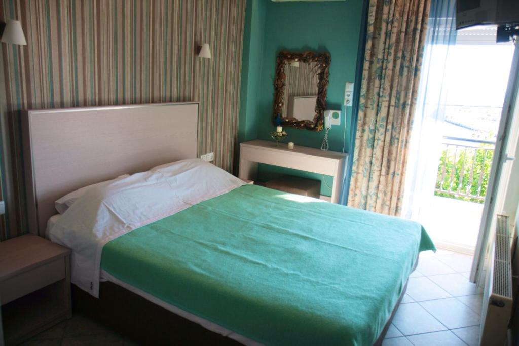 a bedroom with a bed and a mirror and a window at Margarita's Rooms in Potos